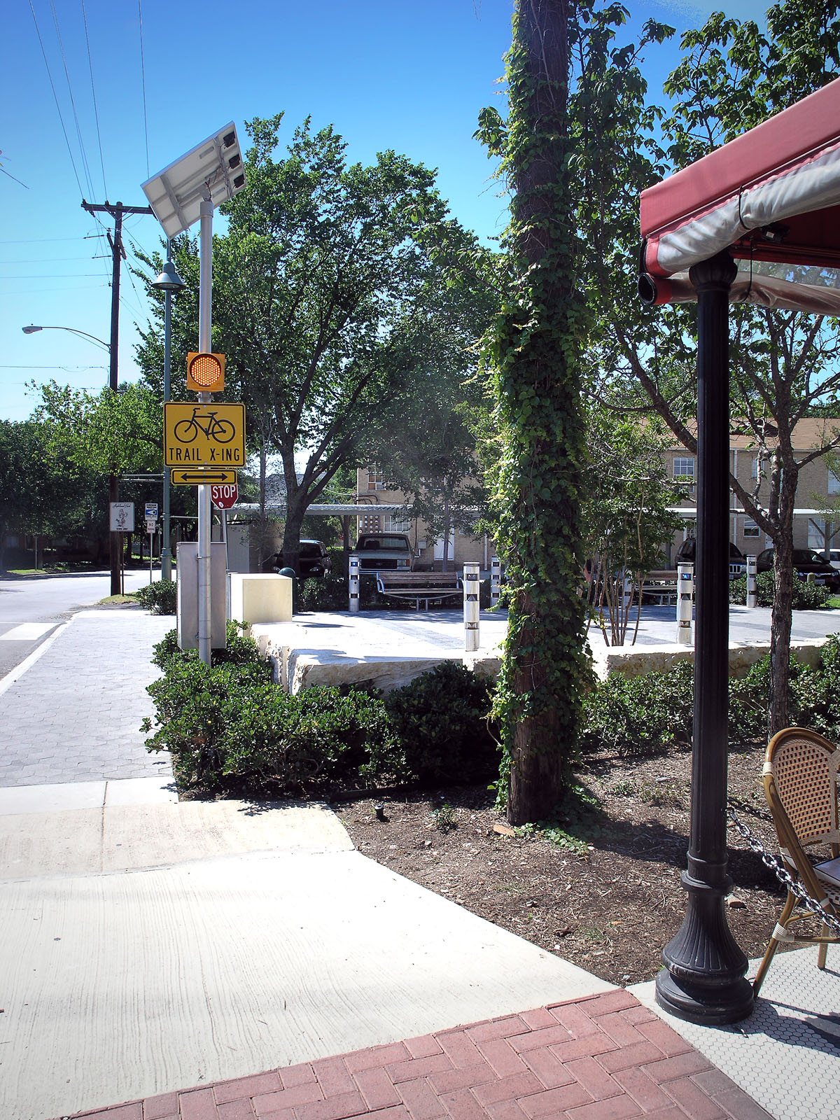 Tree-lined running and biking path on the Katy Trail in Dallas with runners