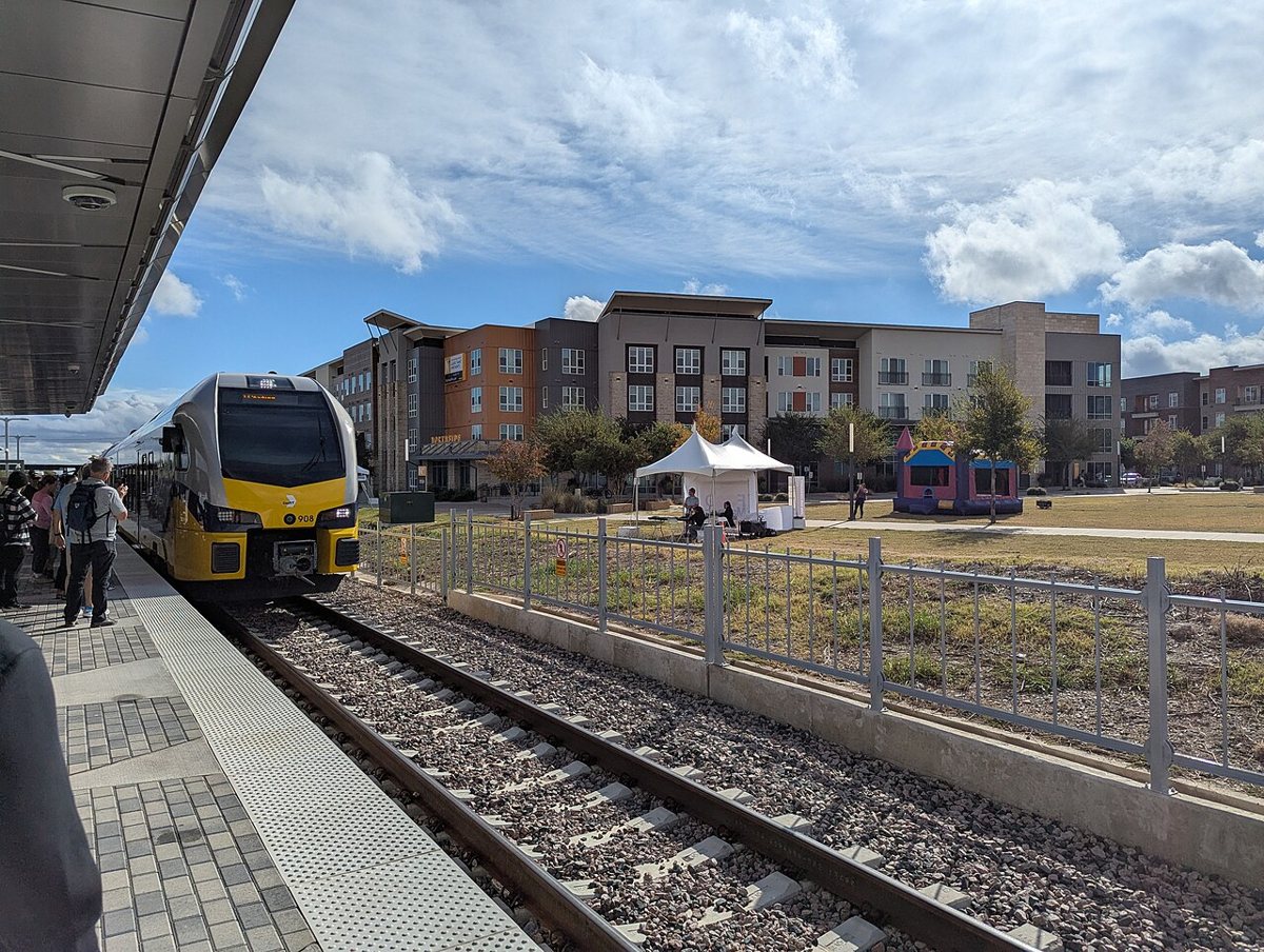 a DART Green Line train arriving at a station platform